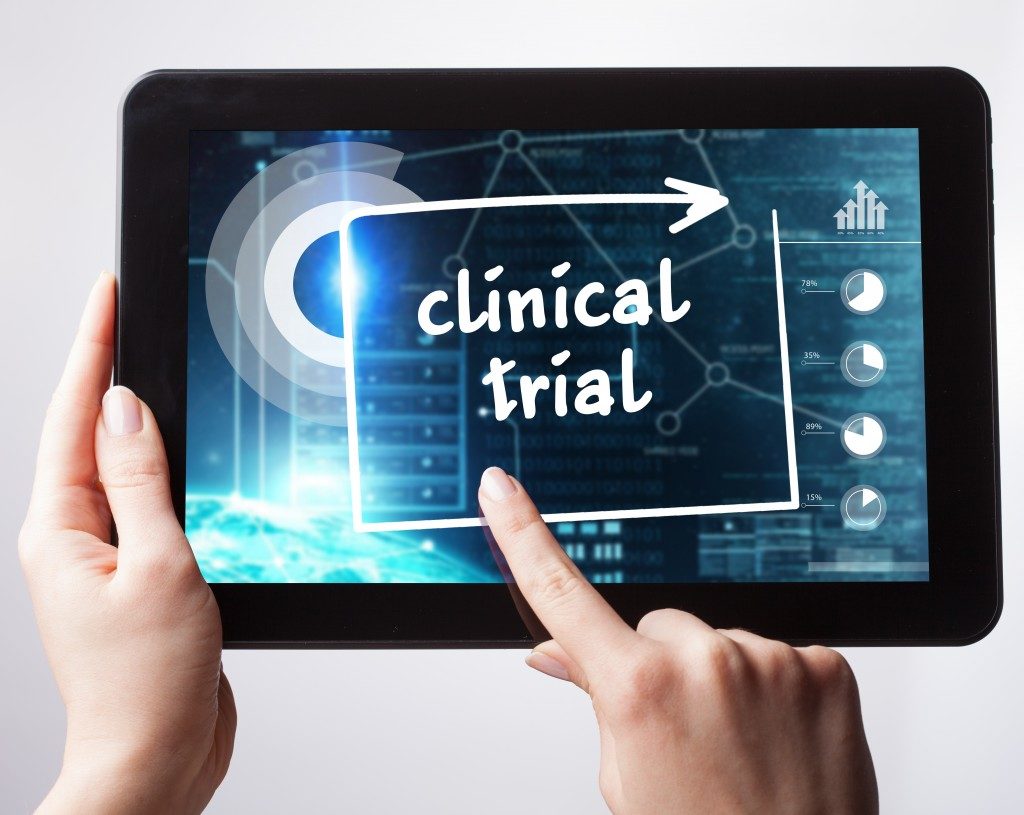 tablet with clinical trial word being pushed