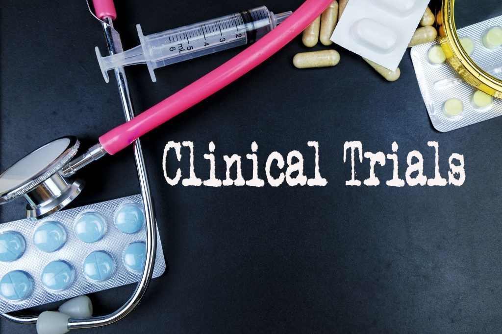 clinical trials word with medicine and medical tools