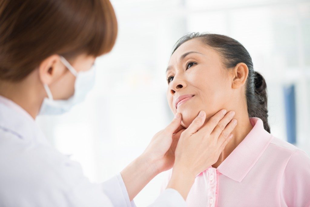 Woman getting her thyroid checked