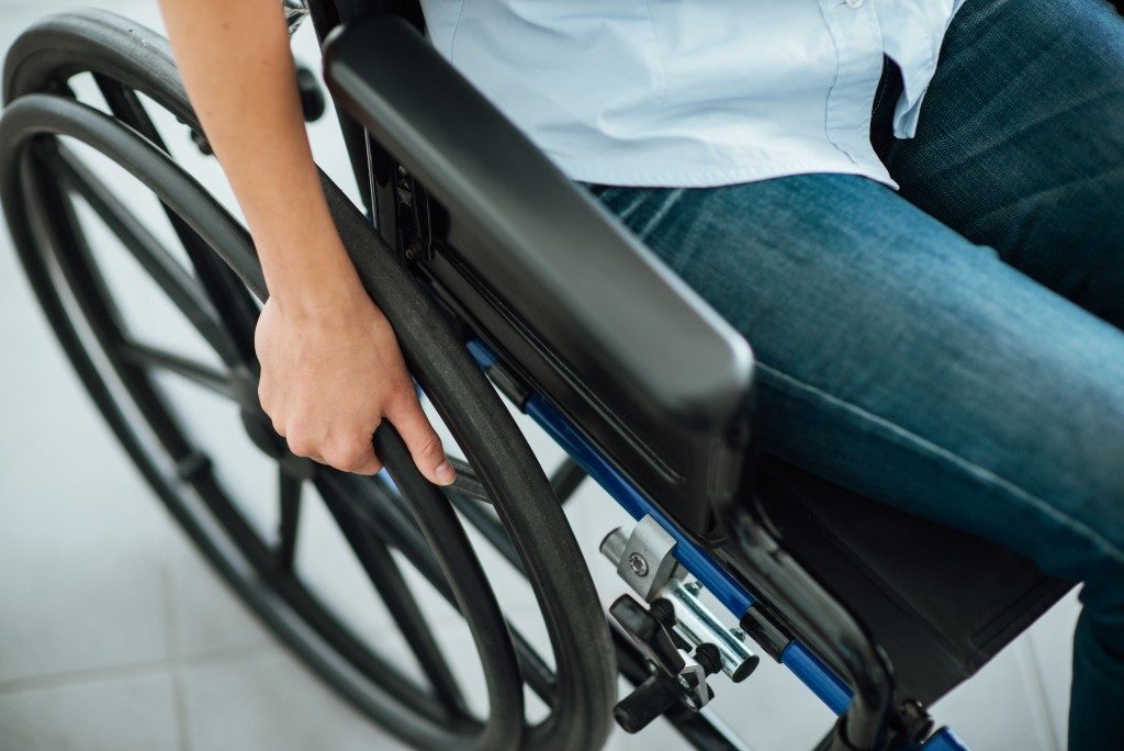 Close up of person sitting on wheelchair
