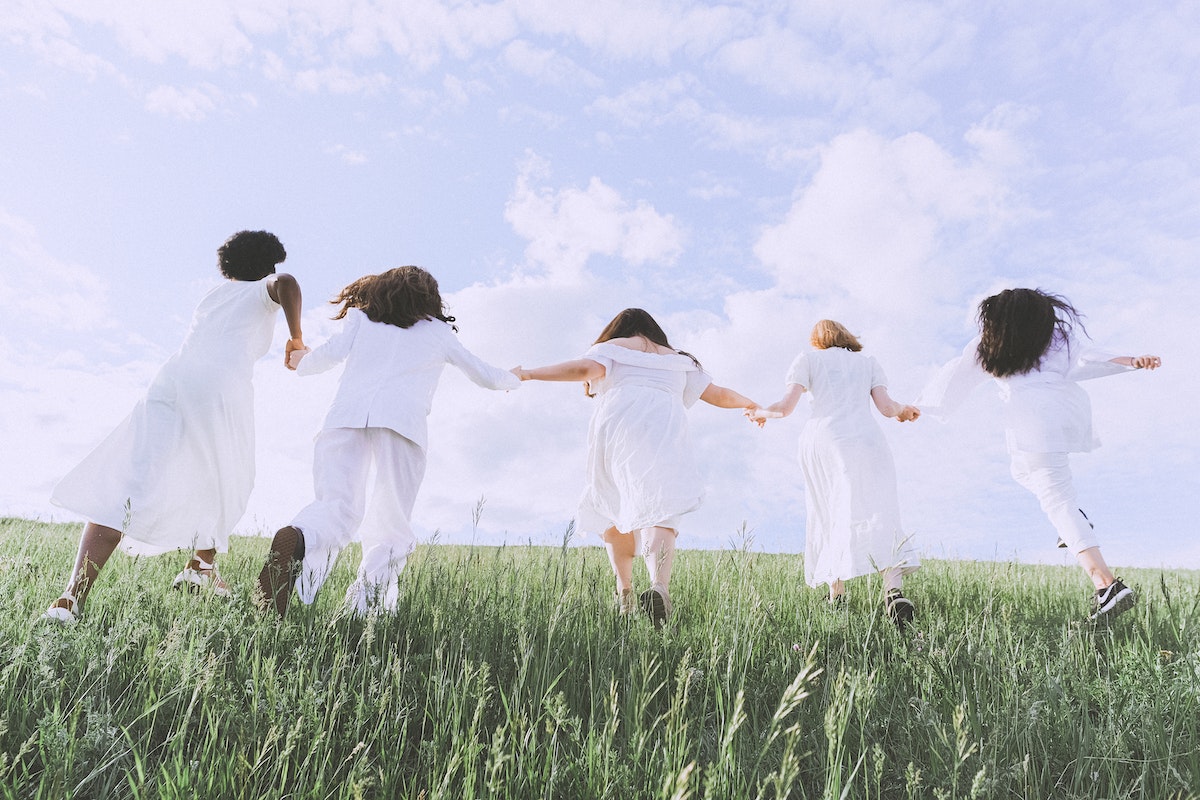 Women in White Dress Running on Green Grass Field