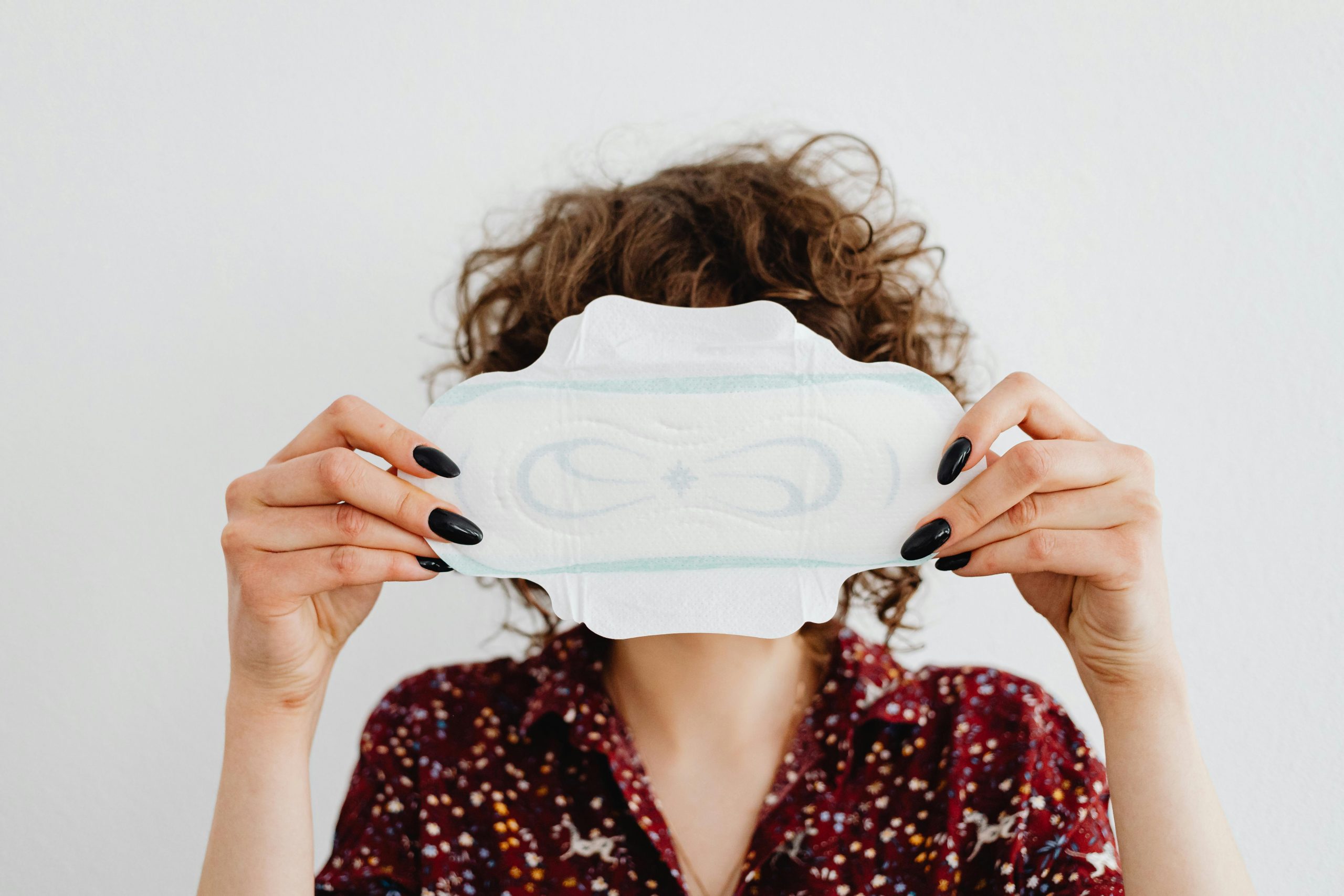 woman holding a sanitary napkin